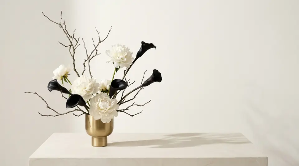 Editorial illustration of white peonies and black calla lilies in a brass vessel